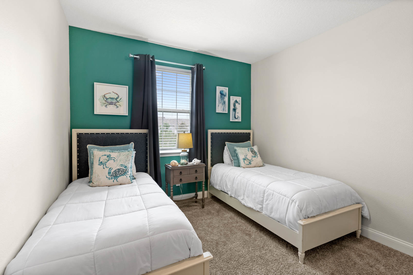 bedroom with double beds and teal wall